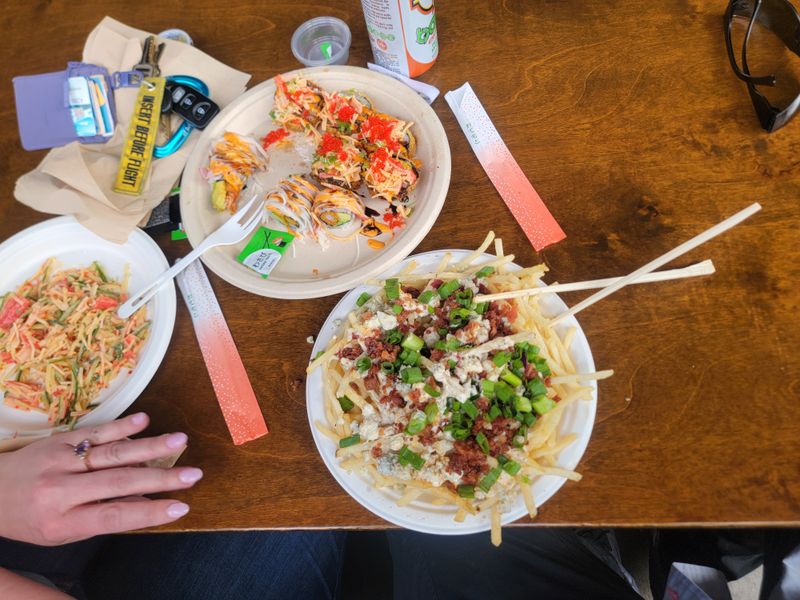 Sushi Rolls Next To Smash Patties