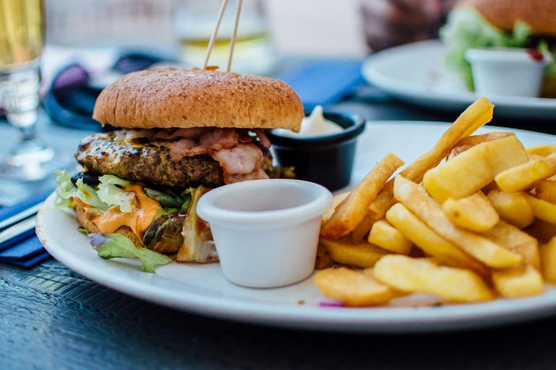10 Restaurant-Style Dishes You’ll Actually Want to Cook at Home – From Classic Burgers and Caesar Salad to Buddha Bowls, Loaded Fries and Indian Thali 14 Bacon Cheeseburger with Fries