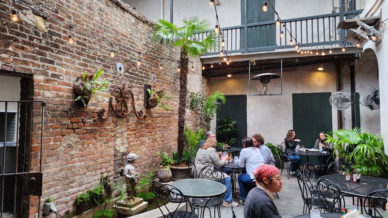 This Louisiana French Quarter Café Serves Warm Muffulettas So Good, Every Bite Feels Like Its Own Little Holiday 11 Courtyard Vibes In The Back