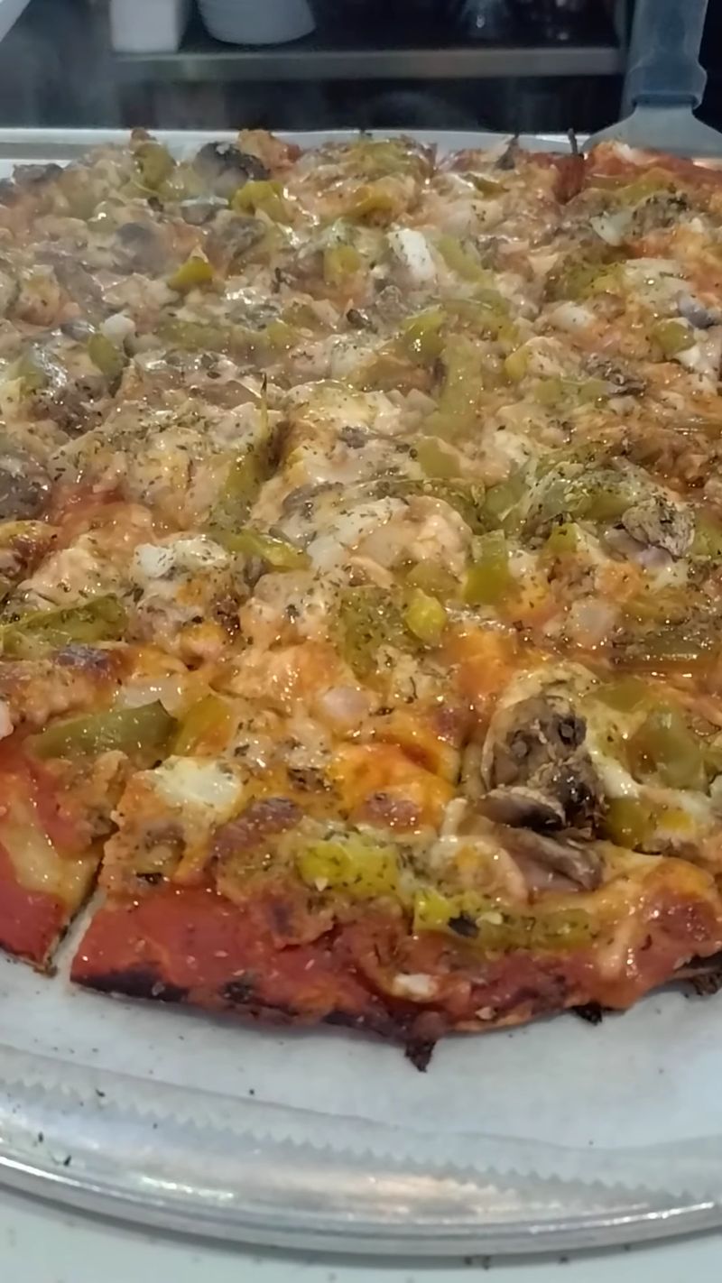 This Chicago Pizza Spot Serves Thin Crust Pizza Locals Say Is The Real Deal 10 That Unmistakable Cheese Pull