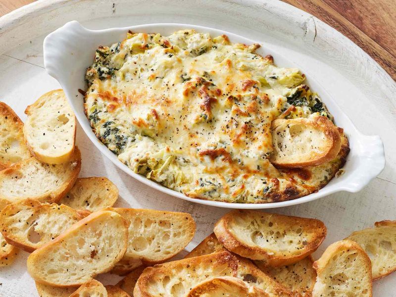 20 80s Party Foods That Look Wrong Now - But Were a Big Deal 15 Spinach dip in bread bowl