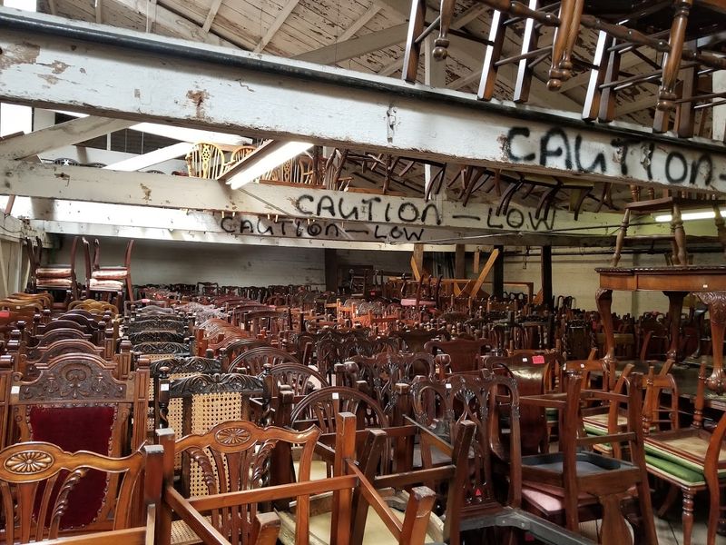 Antique Chairs Stacked to the Ceiling