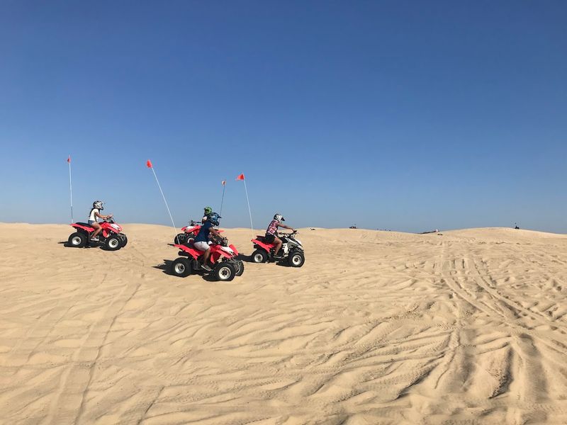 ATV and Off-Road Vehicle Riding Across The Dunes