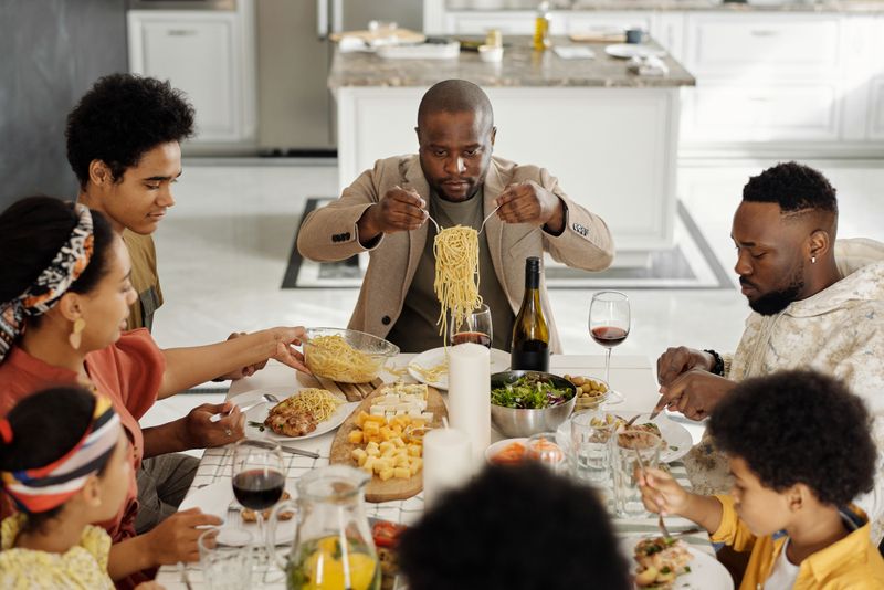 Eating together at the dinner table Eating together at the dinner table