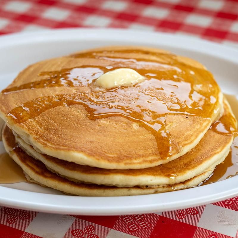 French Toast, Eggs, and Pancakes All on One Table