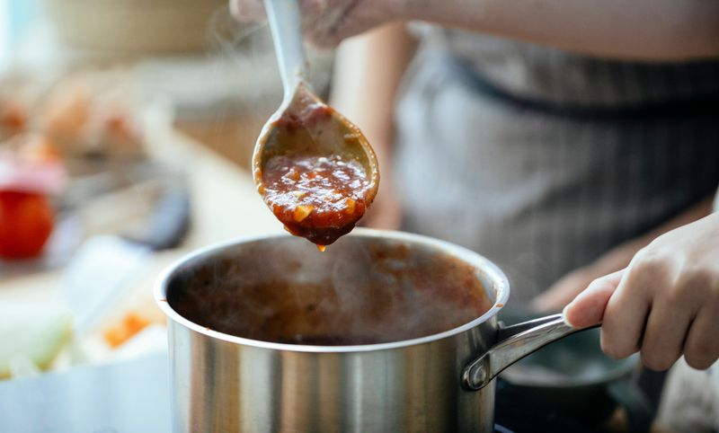 Stirring sauces by hand Stirring sauces by hand