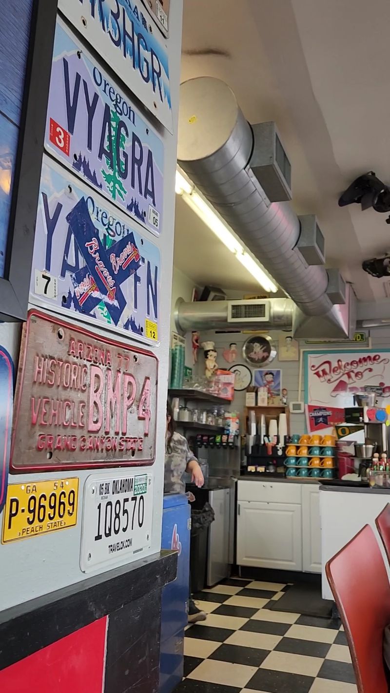 A Gas Pump, A Parking Meter, And A Wall Of License Plates A Gas Pump, A Parking Meter, And A Wall Of License Plates