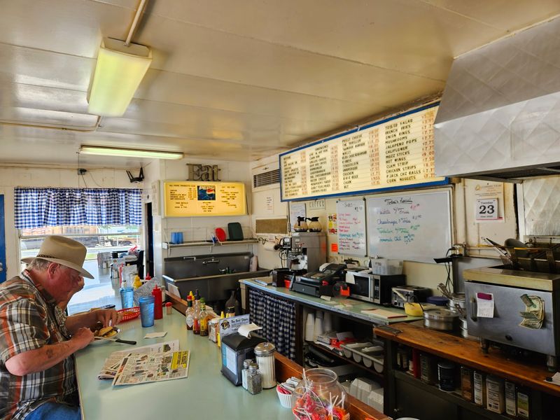 An Open Kitchen And The Cook At The Grill