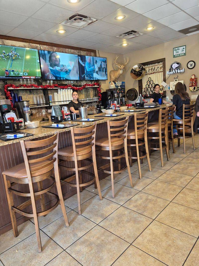Booths, Roosters, And Deer Heads On The Wall