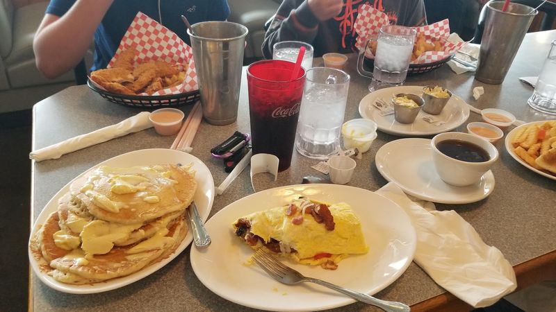Plates Piled High Enough to Hide the Table