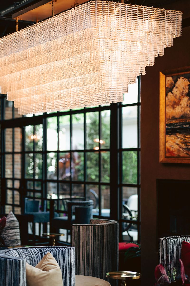 The Grand Bar With A Fireplace And Chandelier