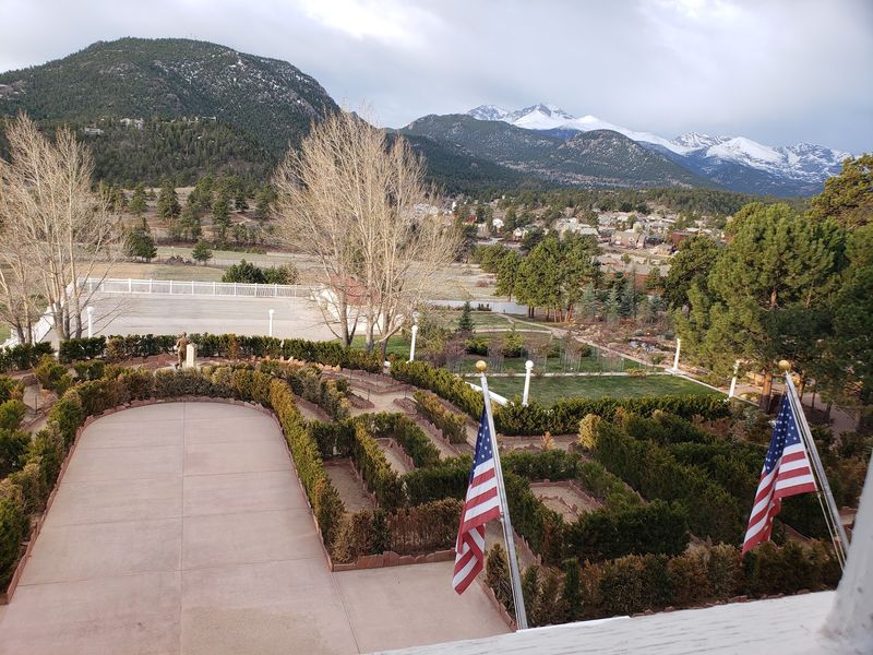 A Hedge Maze With a Mountain Backdrop