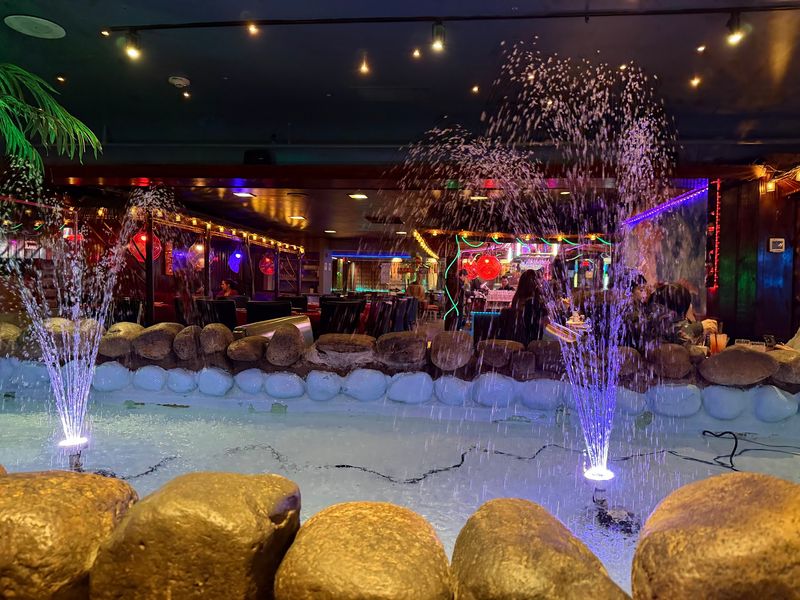 Kitsch, Neon, And A Water Fountain