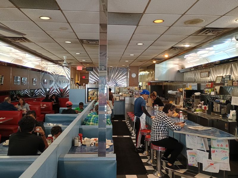 Red Booths, Blue Booths, and a Counter with Stools