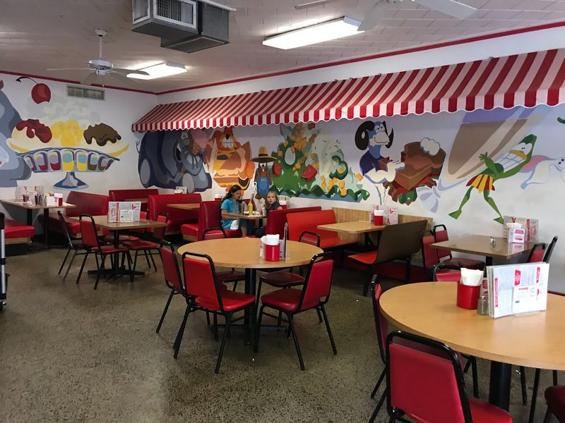 Red Booths and Murals Frozen in Time Red Booths and Murals Frozen in Time