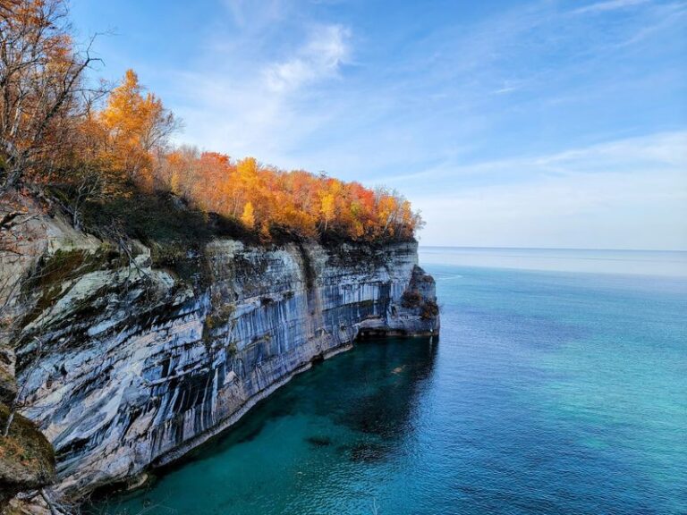 This Michigan Lakeshore Hides Multiple Waterfalls and Towering Sandstone Cliffs Along Its Rugged Trails