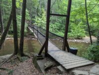 This Small Pennsylvania State Park Tucks Rainbow Falls a Short Walk From the Lot, Beside a Suspension Bridge