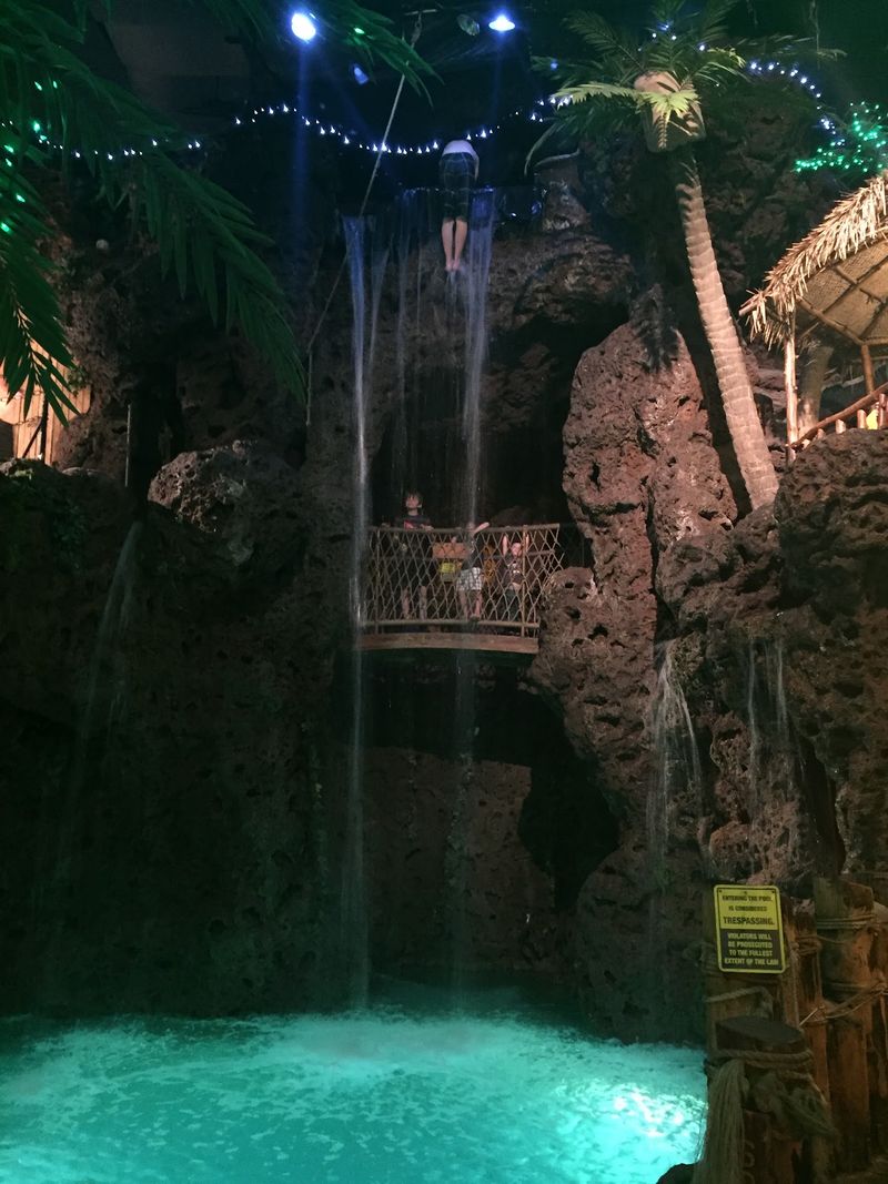 Divers Under a 30-Foot Waterfall